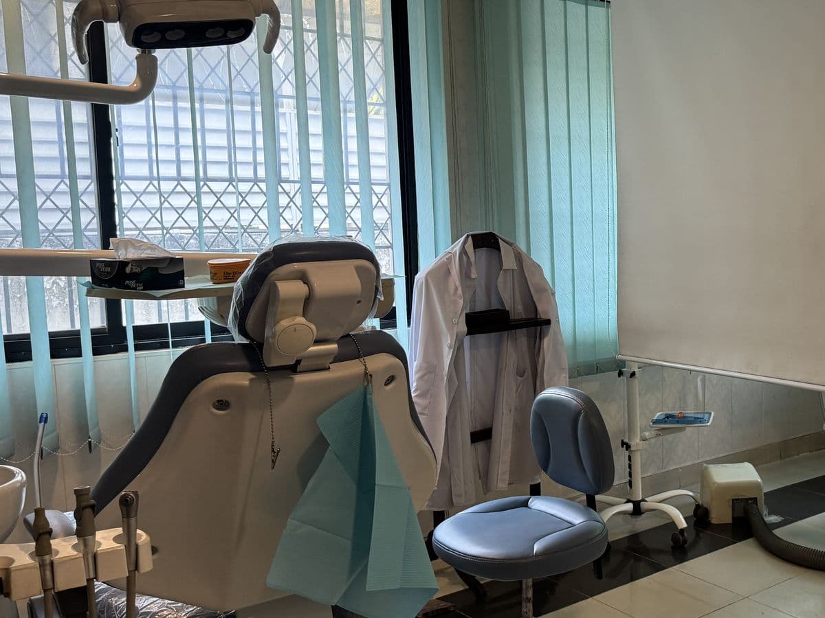 A dental chair and stool, set up and waiting for the next appointment.